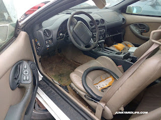 Tan Prado leather interior on 1999 Pontiac Firebird with W68 Appearance Package in junkyard.