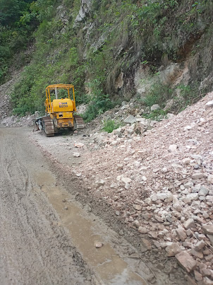 EXCAVATOR for clearing up a landslide on the highway.