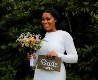 Bride holding flowers and bride sign after botox treatment