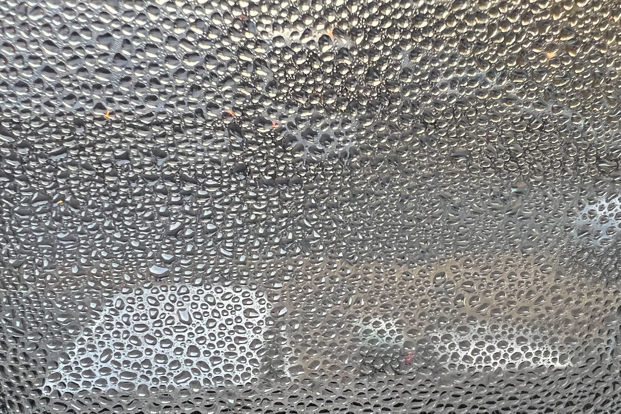 A window covered on droplets of condensation