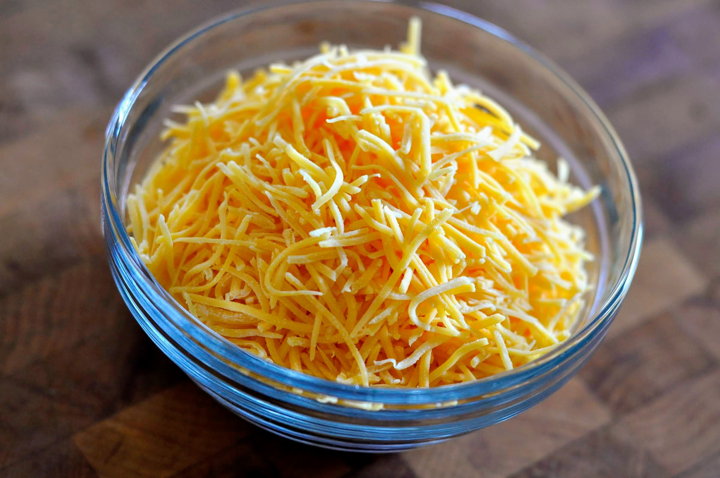 Glass Bowl of Finely Shredded Cheddar Cheese | Taste As You Go
