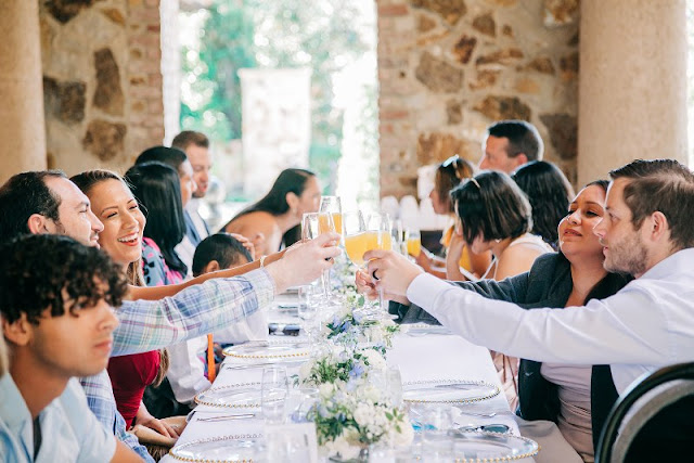 people at wedding cheersing at reception table
