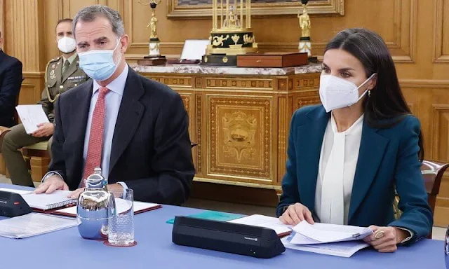 Queen Letizia wore a green wool blend longline suit from Carolina Herrera, and a silk bow blouse from Hugo Boss