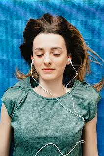 Women relaxing with earbuds in.