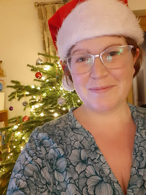 Woman in Santa hat with Christmas tree