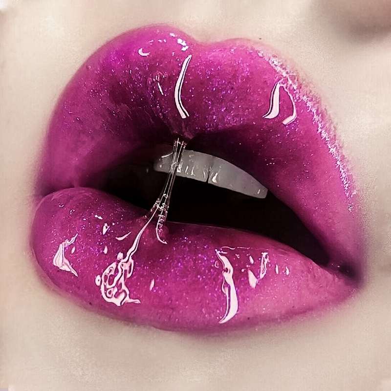 close up of a plump women lips with an aesthetic glossy magenta lipstick