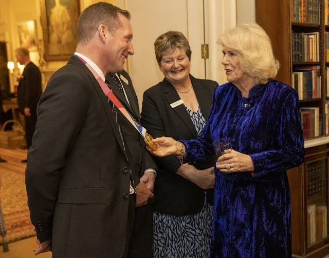 The Duchess wore a blue velvet coat dress. She finished her ensemble with a pair of black boots and dangly earrings