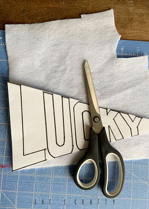 Overhead shot of white felt and lucky flag pattern.