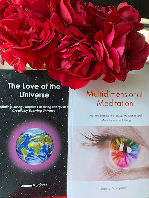 Image of a bunch of red roses, arranged above two books by Leanne Margaret: The Love of the Universe, and Multidimensional Meditation