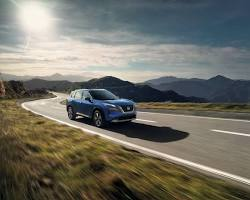 Nissan Rogue driving on a scenic road