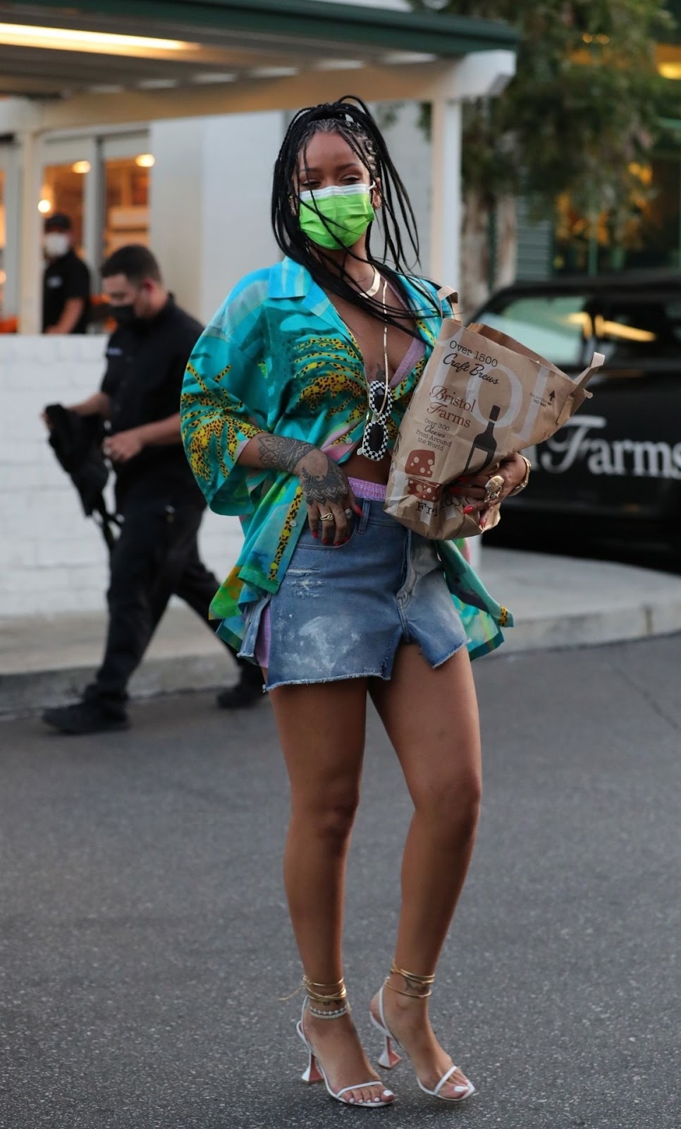 Rihanna is spotted during a grocery run at Bristol in tropical-themed shirt and micro blue jean skirt