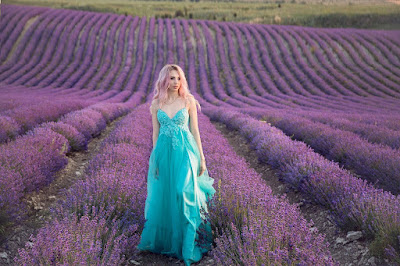 model wearing light color dress amongst lavender