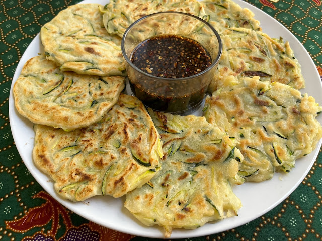Food Lust People Love: Hobak Jeon aka zucchini pancakes are a savory snack popular in Korean cuisine that are made with small pieces of zucchini in a thick batter and fried until crispy with a little oil. Dip them in a spicy sauce to complete this delicious dish!