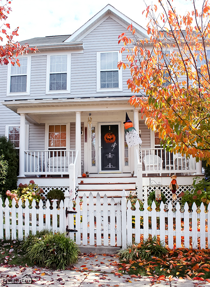 cottage house with front porch decorated for Halloween