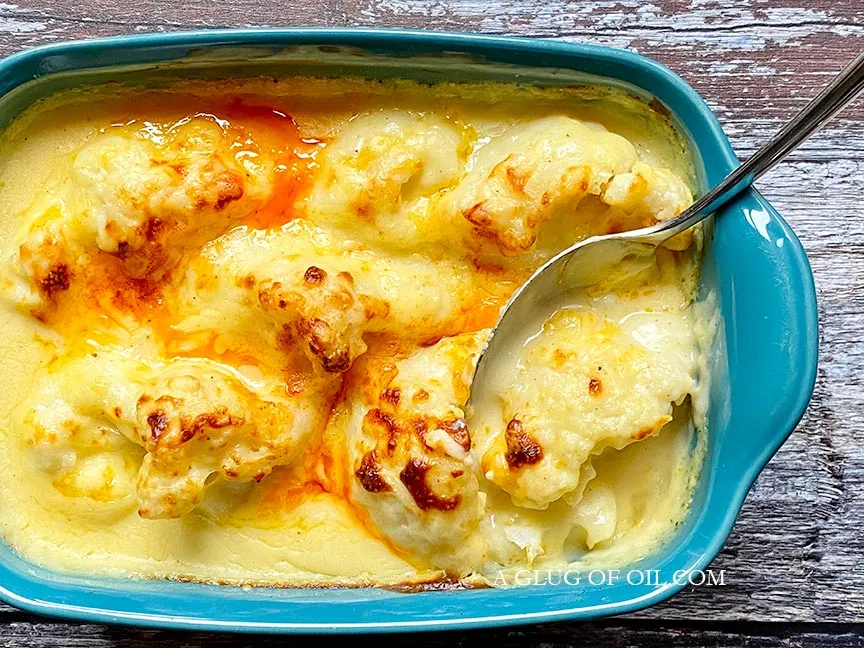 Homemade cauliflower cheese fresh out of the oven in a dish.