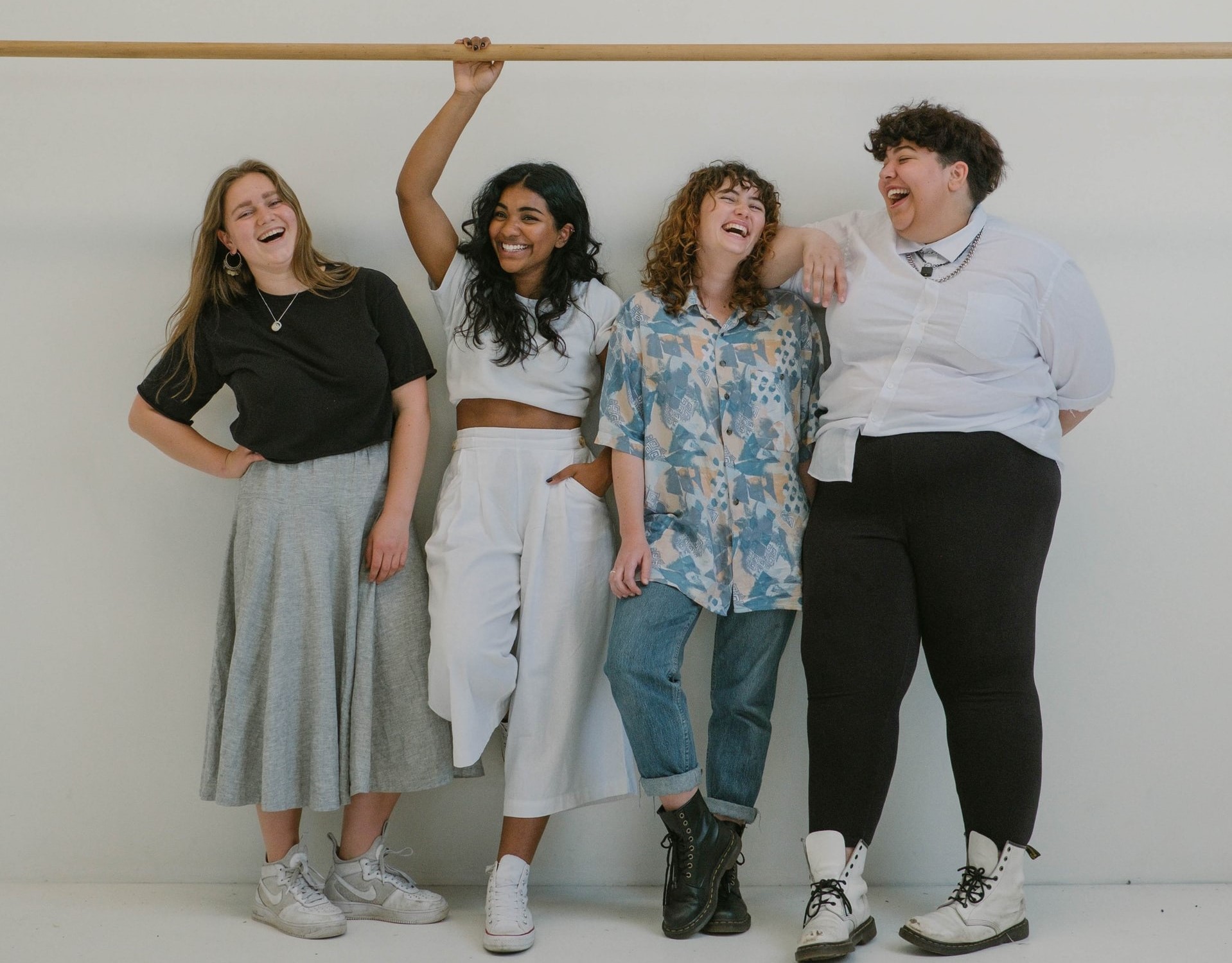 4 women laughing and standing and socializing. Lifenatphil