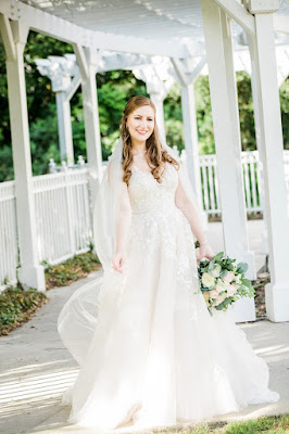 bride smiling in dress with flowers