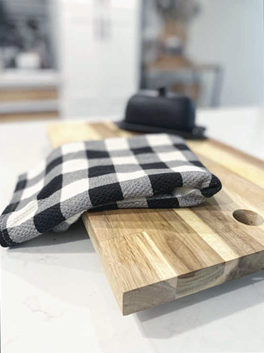 butter dish and tea towel on cutting board