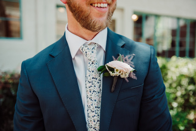 groom smiling with boutonniere