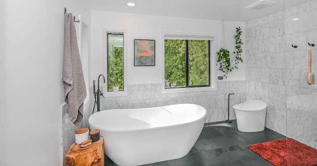 Wet room bathroom with freestanding tub and shower.