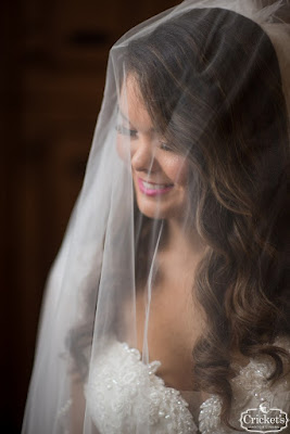 bride smiling under wedding veil