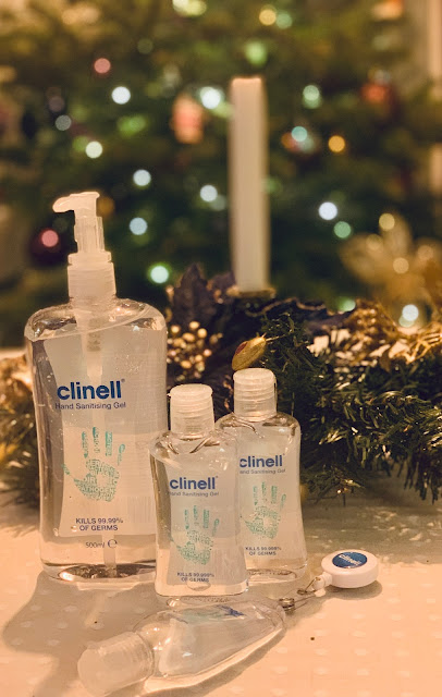 Clinell hand sanitisers on table with Christmas tree in background