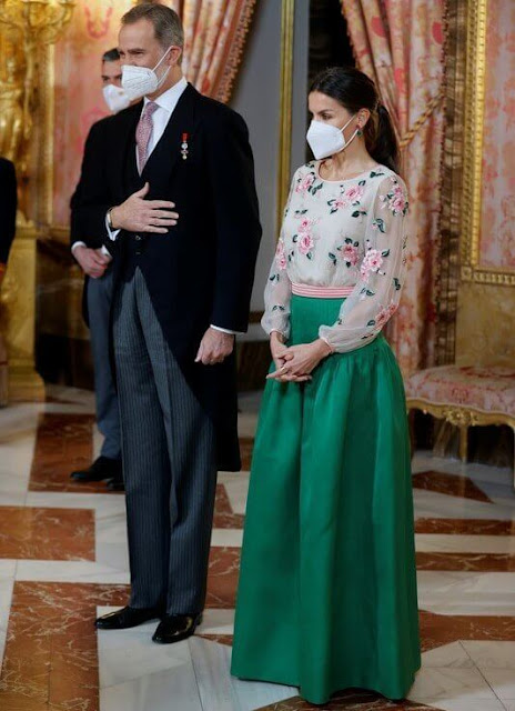 Queen Letizia wore a floral print blouse and green skirt. Queen Letizia is wearing her mother-in-law, Queen Sofia's blouse