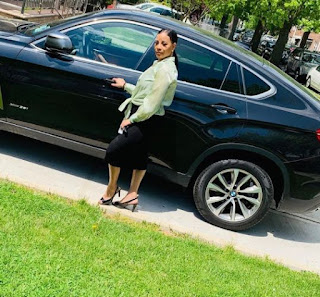 Valerie Vaughn posing for a picture with the car