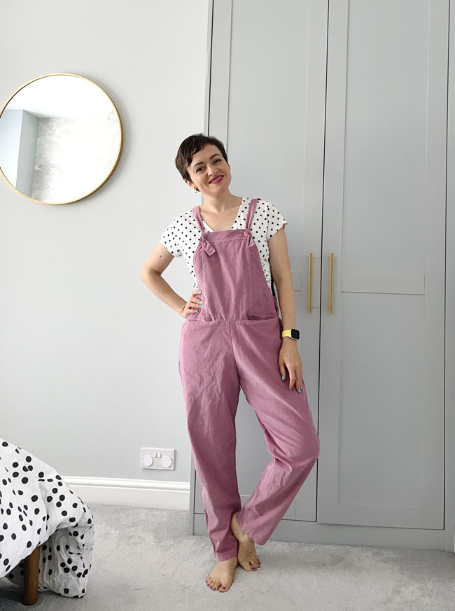 Tilly wearing easy-fitting dungarees in pink needlecord