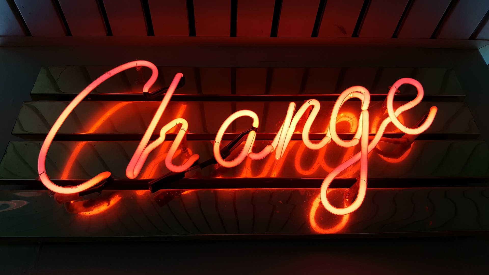 Orange neon signboard saying Change