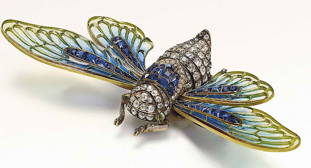 a 1902 glass broach, a blue glass moth