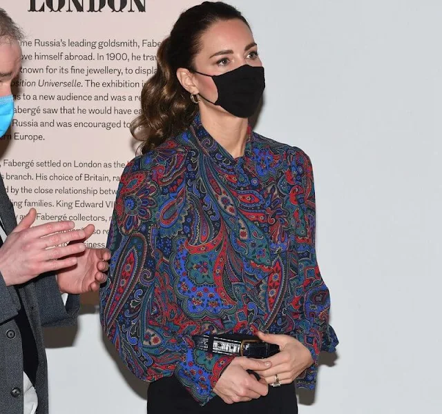 Kate Middleton, Duchess of Cambridge wore a new paisley georgette tie-neck shirt by Ralph Lauren. Black trousers, gold earrings