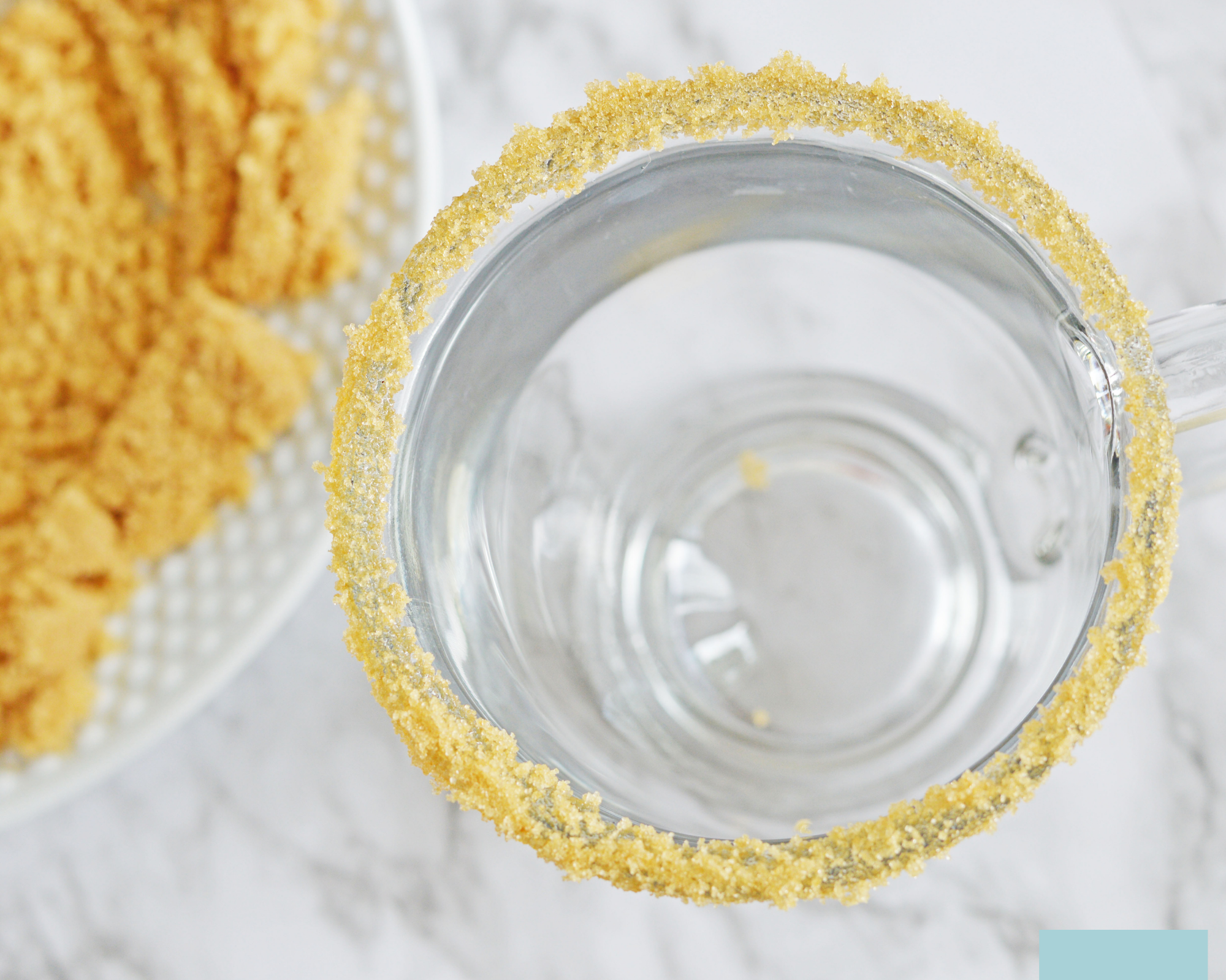 A glass with brown sugar on the rim