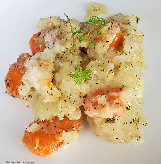 potato and carrot medley on a white plate with butter and garlic oil