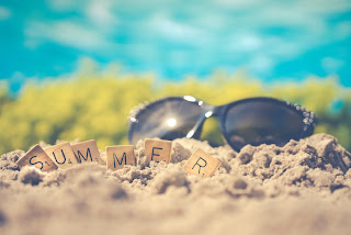 Summer letter tiles, sand, and sunglasses