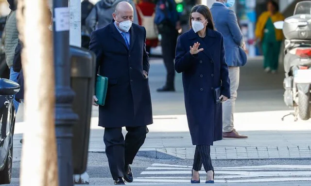 Queen Letizia wore kocani striped blazer and trousers suit from Hugo Boss, and navy wool coat from Hugo Boss