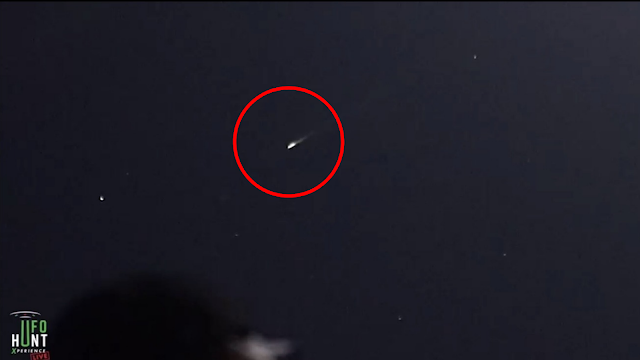 UFO shoots past the Earth leaving a white trail which means it's not a meteorite.