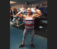 Female bodybuilder Jackie Hague pumps her muscles backstage at the UKBFF North West bodybuilding competition