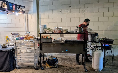 Chef prepares lomo saltado in a wok