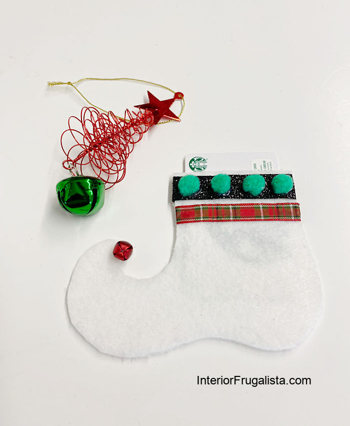 White handmade felt elf shoe gift card holder for the holidays.