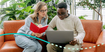 two people looking at laptop together photo