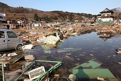 Debris in flooded street at Uranohama Port, Japan, on 1 April 2011, in aftermath of earthquake and subsequent tsunami. US Dept of Defense, image ID 110401-M-GX324-108. Lance Cpl. Brennan O'Lowney, US Marine Corp