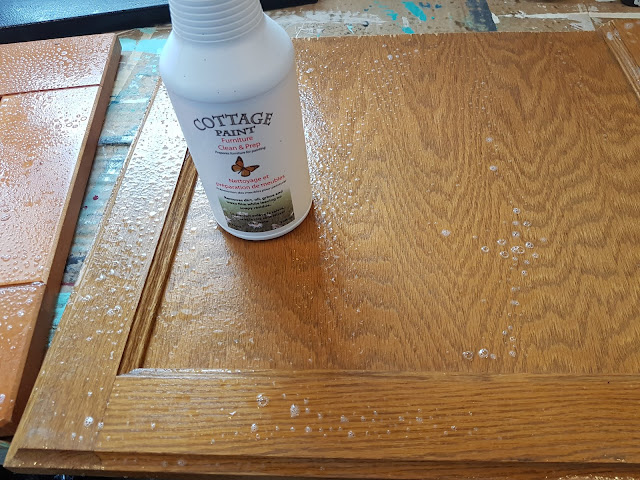 using Cottage Paint cleaner on a cabinet door