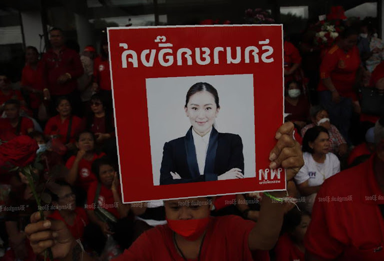 Supporters brandish a portrait as Thailand’s cabinet shake-up amplifies skepticism.