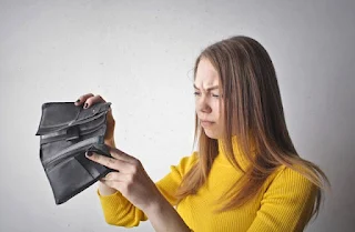 Woman Holding Black Empty  Wallet after loosing her job