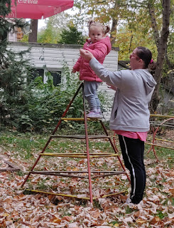 Proud on the top rung of the climbing frame