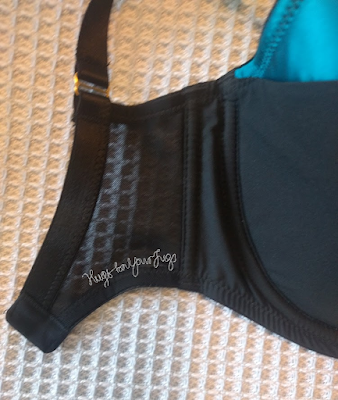 A bra lying flat with a very short "wing"
