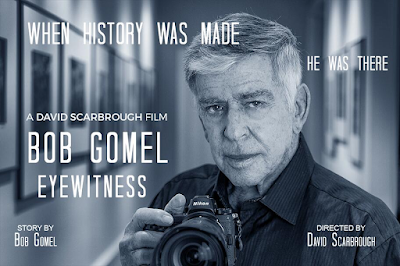 Graphic advertisement for movie screening of "Bob Gomel Eyewitness" with text over black and white photograph of Bob Gomel holding his camera