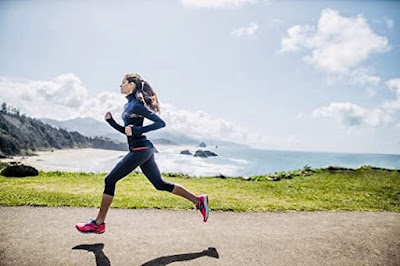 A woman running in a beautiful scenic background