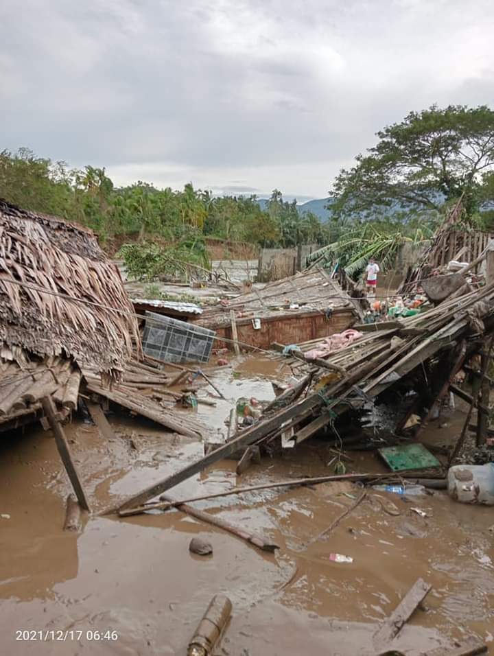 Woman tearfully poses next to her house destroyed by Typhoon Odette